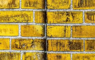 Detailed view at a colorful old and weathered brick wall texture as a panoramic background. photo