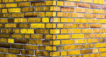 Detailed view at a colorful old and weathered brick wall texture as a panoramic background. photo