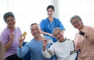 Old people's companions displaying a credit card to guarantee the availability of funds photo