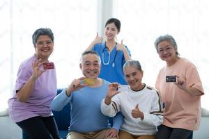 Old people's companions displaying a credit card to guarantee the availability of funds photo