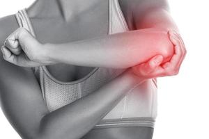 Woman with source of pain in her elbow photo