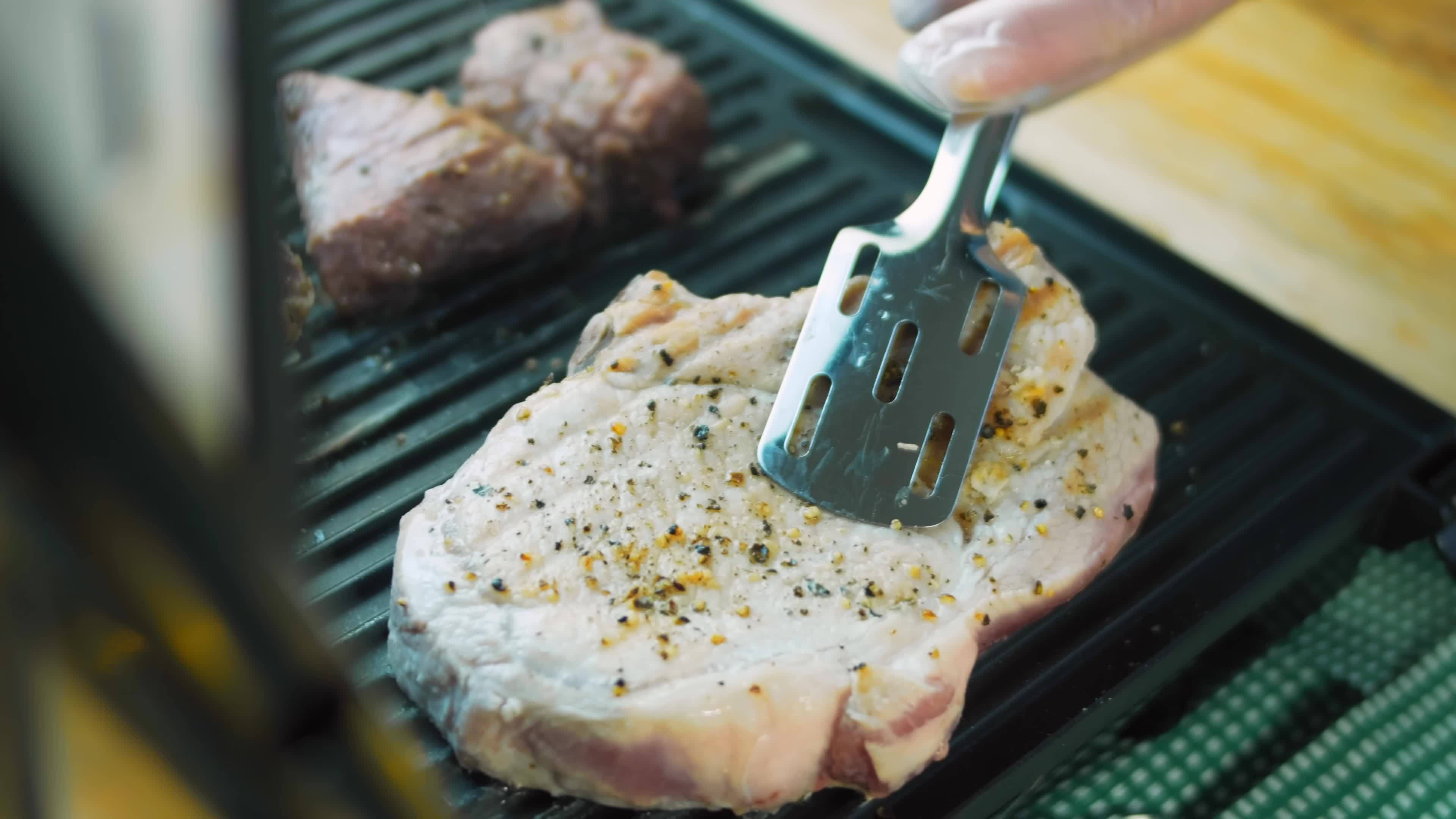 The chef grills pork and beef on the grill 14403381 Stock Video at Vecteezy