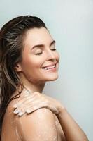 Sensual woman washing her body with shower gel photo