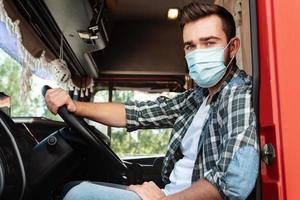 Young truck driver wearing protective mask photo