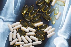 Close-up of X-ray image and different pills and capsules photo