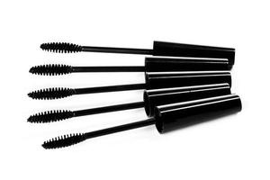 A lot of black Mascara wands on white background photo