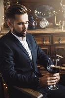 Handsome bearded man with a glass of red wine photo