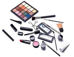 Different makeup objects and cosmetics on white photo