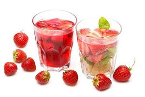 Refreshing drink with red strawberries on white background photo