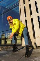 Stylish girl wearing yellow puffer and orange knitted hat photo