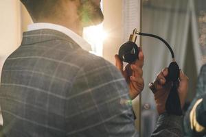 Man is using atomizer nozzle with perfume photo