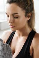 Tired woman with a towel after fitness workout in the gym photo