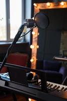 Piano, microphone and mirror in an empty studio photo