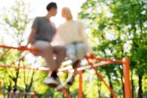 Out of focused image of couple on a playground photo