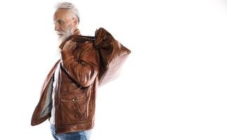 Handsome bearded senior man with leather bag and jacket on white background photo