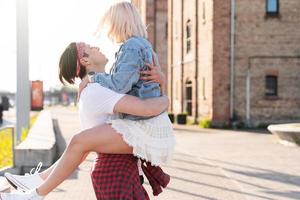 Stylish teenage couple in embrace on a city street photo