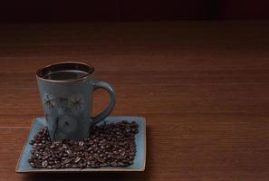 a cup of coffee with coffee beans photo