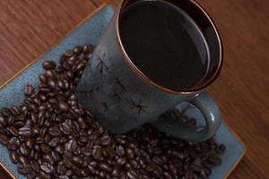 a cup of coffee with coffee beans photo