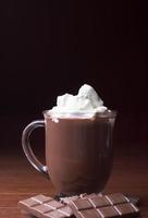 Hot Cocoa in a glass mug with wiped cream photo