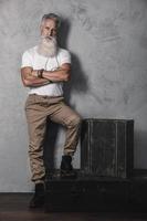 Handsome bearded senior man posing in studio photo