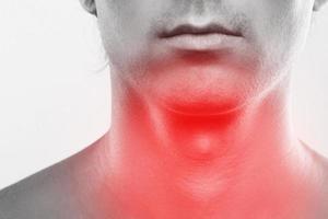 Man with a pain in his neck. Concepts of problems with thyroid or sore throat. photo