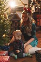 Happy mother and her cute little son are celebrating Christmas or New year. photo