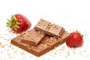 Strawberries and milk chocolate on white background photo