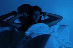 Woman with insomnia because of loud noises photo