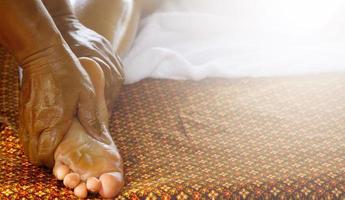 Closeup of female feet during traditional Thai massage photo