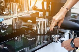 Barista is making coffee in coffee shop photo