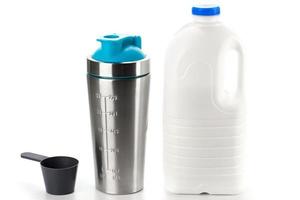 Metal protein shaker and big bottle of milk photo