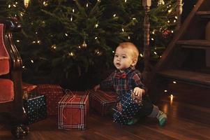 Little boy wearing checkered shirt at home during Christmas eve. photo