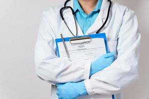 Doctor holding folder with a coronavirus test form photo