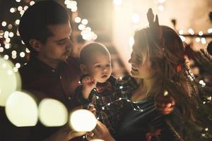 Happy mother and her cute little son are celebrating Christmas or New year. photo