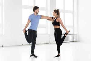 Fitness man and woman during workout with in the gym photo
