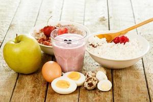 Healthy breakfast. Different food on wooden table. photo