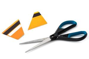 Scissors and cut credit card on white photo