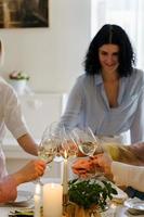 Young women friends clinking glasses at the festive table. photo