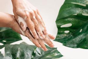 Closeup of female hands with cleansing foam photo