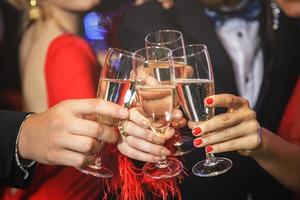 Hands with a full glasses of sparkling wine photo