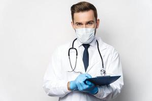 Doctor is holding the clipboard with a documents photo