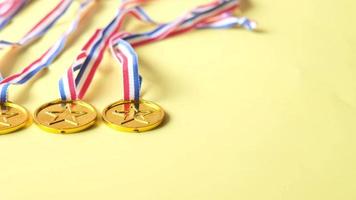 Gold star medals dangle on yellow background video