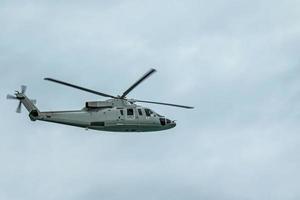 Military gray navy helicopter flying in the sky photo