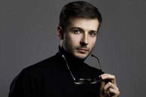 Young intelligent man wearing turtleneck and eyeglasses photo