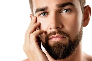 Young and handsome bearded man with smooth skin photo