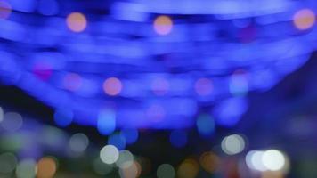 Blurred background in the night market, the light from the lamps creates zonal bokeh. by blue bulb video