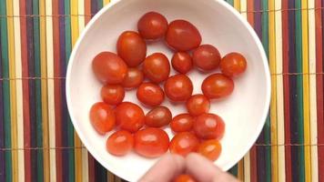 Small tomatoes in white bowl video