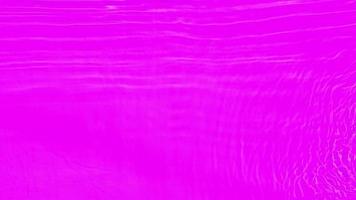 Defocus blurred transparent purple colored clear calm water surface texture with splashes and bubbles. Trendy abstract nature background. Water waves in sunlight with copy space. Watercolor shine video