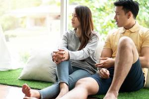 Unhappy Couple sitting beside each other on the floor and avoid talking or quarrel, Cause of relationship problems and having misunderstanding or disagreement. Family problems concept photo