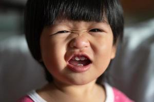 An adorable little girl Laughing and big smile in the morning. Concept of happy childhood photo